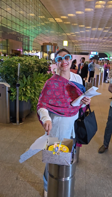 Kajol cuts birthday cake with paps at airport, shy Nysa Devgn stays out of frame